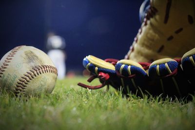 Close-up of baseball equipment on playing field