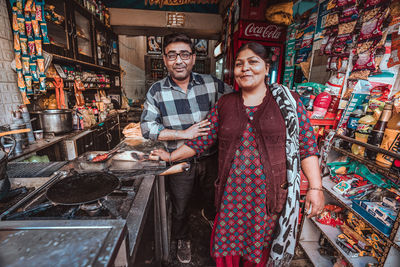 Portrait of a smiling young man standing at store