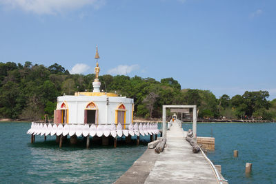 View of building by sea against sky