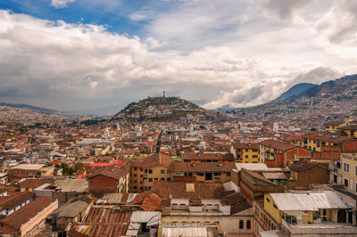 Cityscape against cloudy sky