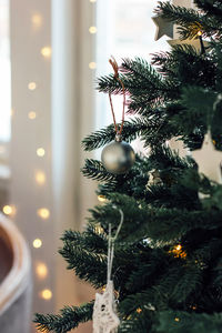 Close-up of bauble hanging on christmas tree at home