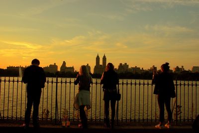 Silhouette people against sky during sunset