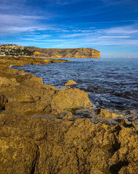 View of rocks on beach against sky