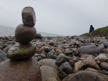 Pebbles on beach against sky