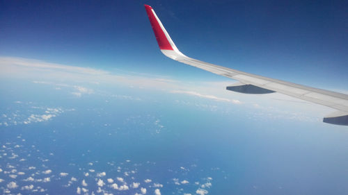 Aerial view of airplane flying in sky