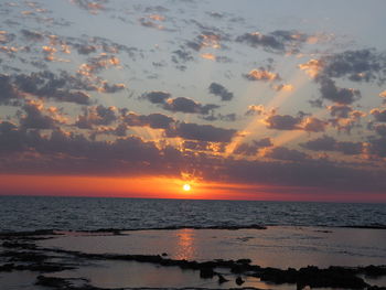 Scenic view of sea against orange sky