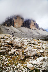 Scenic view of dolomites against cloudy sky