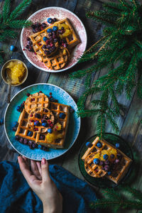 Cropped hand of person holding food on table