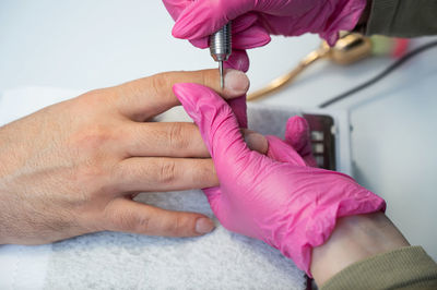 Cropped hand of man repairing car