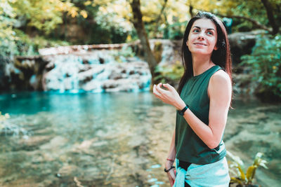 Portrait of smiling woman standing outdoors