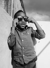 Portrait of boy with gap toothed wearing sunglasses during sunny day