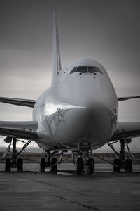 Airplane on runway against sky