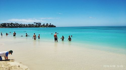 People on beach against sky