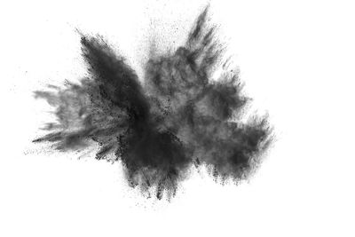 Defocused image of black powder paints against white background