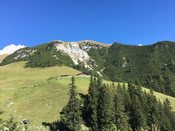 Scenic view of mountains against clear blue sky