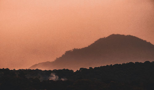 Scenic view of silhouette mountains against sky during sunset