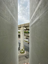 Bridge over road against sky in city