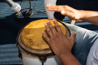 Hands of a percussionist playing atabaque in a performance in the ribeira neighborhood 