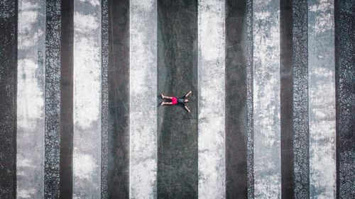 Aerial view of man lying on footpath