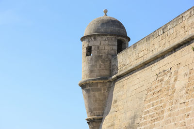 Low angle view of historical building against clear blue sky