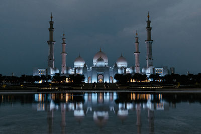 Reflection of illuminated buildings in lake