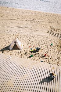 High angle view of umbrellas on sand at beach