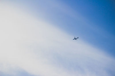 Low angle view of airplane flying in sky