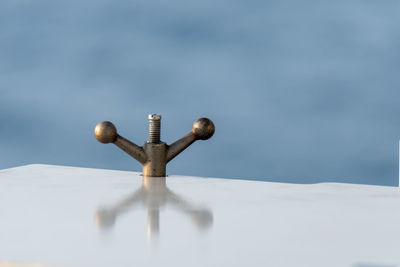 Close-up of snow on table against sky