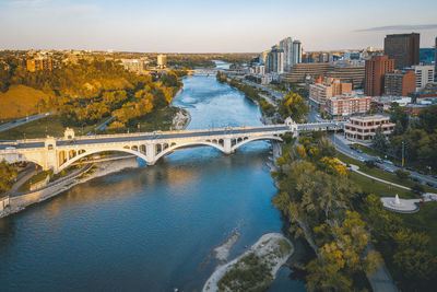 High angle view of bridge over river amidst buildings in city