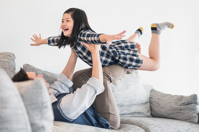 Rear view of happy girl on sofa