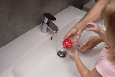 Midsection of woman in bathroom at home