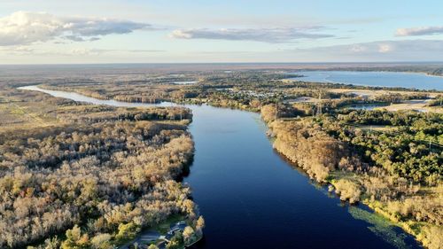 High angle view of river amidst landscape against sky