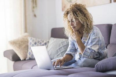 Young woman using laptop at home