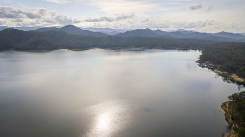 Scenic view of river and mountains against sky