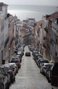 High angle view of cars on street in front of sea