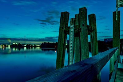 Pier over lake against sky at dusk