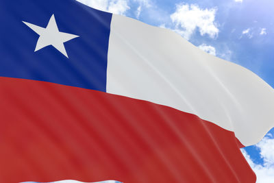 Low angle view of flag against blue sky