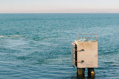 Man standing by sea against sky