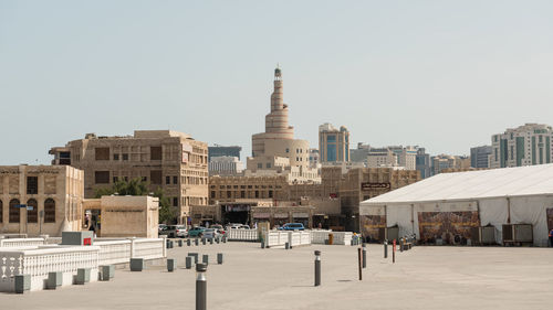 Buildings in city against clear sky