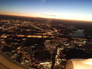 Aerial view of city against sky at dusk