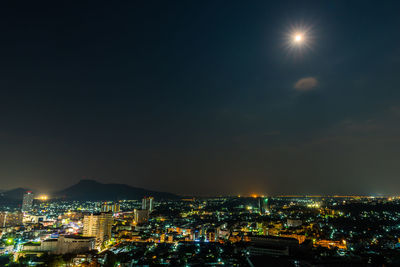 High angle view of illuminated townscape against sky at night