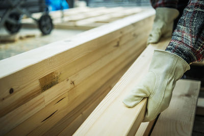 Low section of man sitting on wood