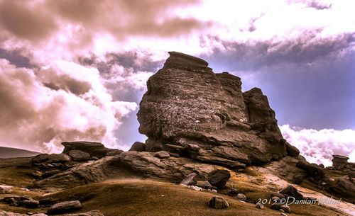 Scenic view of landscape against cloudy sky