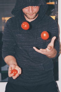 Close-up of man holding balloons