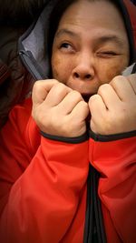 Cheerful woman wearing red fake fur