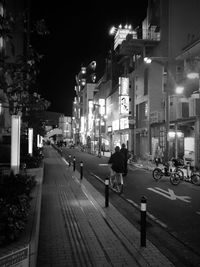 Illuminated street lights in city at night