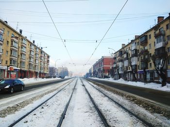 Railroad tracks against clear sky during winter