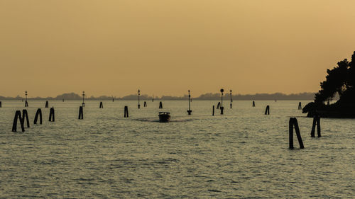 Scenic view of sea against clear sky during sunset