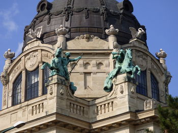 Low angle view of statue against historic building