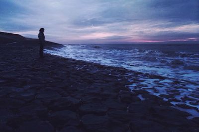 Scenic view of sea against cloudy sky